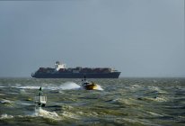 Container ship sailing on Westerschelde river, towards open sea, after visiting Antwerp harbour — Stock Photo