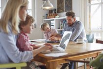 Parents and sons working in home office — Stock Photo