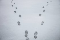 High angle view of footprints in snowy landscape — Stock Photo