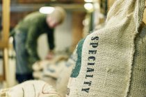 Gros plan du sac de grains de café de spécialité dans la salle de stockage — Photo de stock