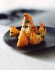 Roasted squash with sesame seeds and herbs on plate — Stock Photo