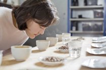 Coffee taster smelling cup of coffee — Stock Photo
