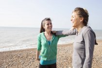 Two women training, on Brighton beach — Stock Photo