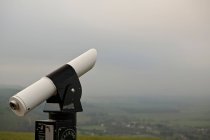 Coin operated telescope and scenic view of town — Stock Photo