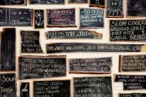 Quirky coffee shop interior with menu on chalked blackboards — Stock Photo