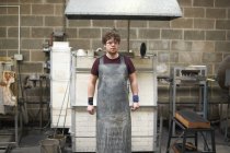 Portrait of glassblower in workshop wearing apron — Stock Photo