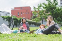Happy Couples relaxing in park together — Stock Photo