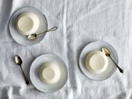 Top view of panna cotta desserts on saucers — Stock Photo