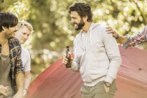 Quatre hommes boivent de la bière en campant dans la forêt, Deer Park, Cape Town, Afrique du Sud — Photo de stock