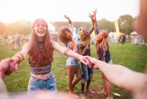 Group of friends at festival, covered in colourful powder paint — Stock Photo