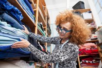 Owner of small fashion business working in material storeroom — Stock Photo