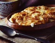 Homemade potato gratin with baked cheese top in vintage dish — Stock Photo