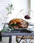 Roast chestnut turkey on patio christmas table — Stock Photo
