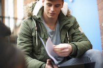 Young male college student revising on campus — Stock Photo