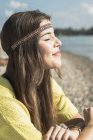 Young woman with eyes closed wearing headband — Stock Photo