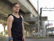 Portrait of young man in sports clothing in urban environment — Stock Photo
