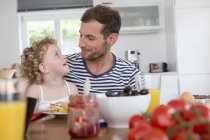 Father and daughter at kitchen table — Stock Photo