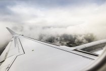 View of clouds and airplane wing above the Pyrenees — Stock Photo
