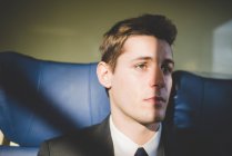Portrait of young businessman commuter on train. — Stock Photo