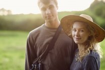 Portrait of romantic young couple in rural field — Stock Photo