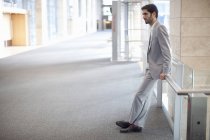 Young businessman waiting conference centre corridor — Stock Photo