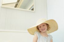 Portrait of girl with sunhat on in holiday apartment — Stock Photo