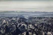 Aerial view of rocky mountains in sunlight — Stock Photo