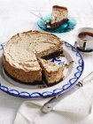 Walnut hazelnut cake on plate and tea cup — Stock Photo