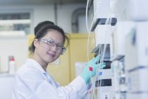 Portrait of young female scientist  using scientific equipment in lab — Stock Photo