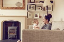Mother and baby boy playing in living room — Stock Photo