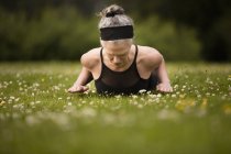 Reife Frau praktiziert Yoga Kobra Pose im Feld — Stockfoto