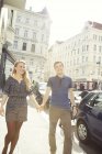 Jovem casal passeando ao longo da rua da cidade — Fotografia de Stock