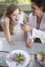 High angle view of couple eating lunch in garden restaurant — Stock Photo