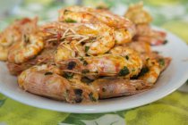 Plate of fried prawns with herbs, close up shot — Stock Photo