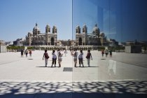 Mirror reflection of tourists and Marseilles cathedral, Marseilles, France — Stock Photo