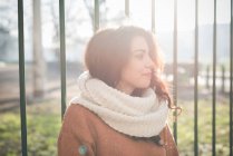 Portrait of beautiful young woman in sunlit park — Stock Photo