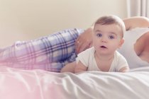 Mother and baby boy resting on bed — Stock Photo