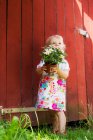 Girl holding potted plant outdoors — Stock Photo