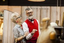 Quirky vintage couple shopping in antiques emporium — Stock Photo