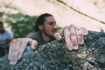Hands of male boulderer gripping boulder edge, Lombardy, Italy — Stock Photo