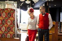 Quirky vintage couple shopping in antiques and vintage emporium — Stock Photo