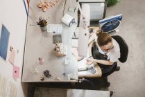 Overhead view of female jeweler at workbench — Stock Photo