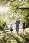 Mother and daughters enjoying park — Stock Photo