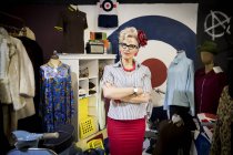 Portrait of vintage mature woman in clothes shop — Stock Photo
