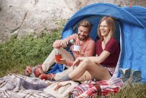 Couple camping, sitting by tent, Krakow, Malopolskie, Poland, Europe — Stock Photo