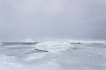 Sheet of glacial ice on frozen lake — Stock Photo