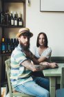 Portrait of cool couple at bar table — Stock Photo