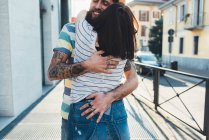 Romantic couple hugging on sidewalk — Stock Photo