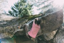 Male boulderer climbing boulder overhang, Lombardy, Italy — Stock Photo