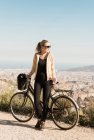 Visita della donna in bicicletta, città sullo sfondo, Barcellona, Catalogna, Spagna — Foto stock